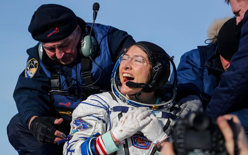 epa08197181 NASA astronaut Christina Koch (front) reacts shortly after landing of the Russian Soyuz MS-13 space capsule in a remote area southeast of Zhezkazgan in the Karaganda region of Kazakhstan, 06 February 2020. A Soyuz space capsule with U.S. astronaut Christina Koch, Russian cosmonaut Alexander Skvortsov and ESA (European Space Agency) astronaut Luca Parmitano, returning from a mission to the International Space Station, landed safely in the steppes of Kazakhstan. Christina Koch returned to the Earth after setting a new record for the longest space mission by a woman. EPA/SERGEI ILNITSKY / POOL