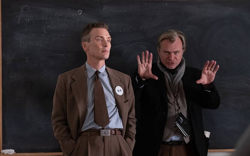 L to R: Cillian Murphy (as J. Robert Oppenheimer) and writer, director, and producer Christopher Nolan on the set of OPPENHEIMER.