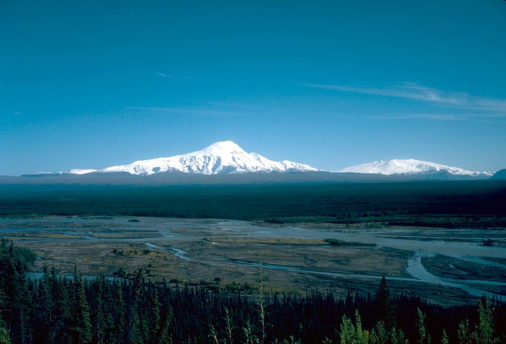 View, looking southeast, of 4,949-m (16,237 ft)-high Mount Sanford (left) and 4,317-m (14,163 ft)-high Mount Wrangell (right) on the skyline. Photograph by D. Richter, U.S. Geological Survey, August 1981, public domain.