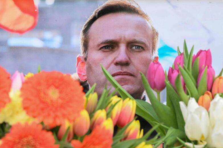 Flowers are seen placed around portraits of late Russian opposition leader Alexei Navalny, who died in a Russian Arctic prison, at a makeshift memorial in front of the former Russian consulate in Frankfurt am Main, western Germany, on February 20, 2024. Navalny's widow Yulia Navalnaya accused Russian President Putin of killing her husband and vowed to continue Navalny's work. (Photo by AFP)