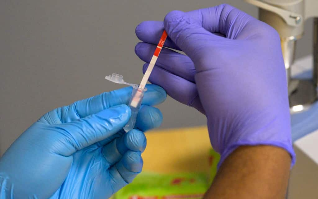 Leonardo Dominguez Gomez, field researcher with the New York City Department of Health, tests a heroin sample for xylazine at St. Ann's Corner of Harm Reduction in New York City on May 25, 2023. The tranquillizer, approved for veterinary use by the US Food and Drug Administration (FDA), has infiltrated the illegal drugs market in the US, with producers increasingly using it to augment fentanyl. Overdose deaths where tranq was detected have soared in recent years and in April the White House designated the drug an "emerging threat." (Photo by ANGELA WEISS / AFP) (Photo by ANGELA WEISS/AFP via Getty Images)