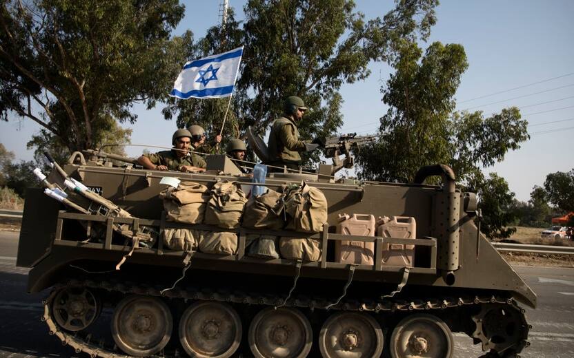 SDEROT, ISRAEL - OCTOBER 8: Israeli soldiers in an armoured personnel carrier head towards the southern border with the Gaza Strip on October 8, 2023 in Sderot, Israel. On Saturday, the Palestinian militant group Hamas launched the largest surprise attack from Gaza in a generation, sending thousands of missiles and an unknown number of fighters by land, who shot and kidnapped Israelis in communities near the Gaza border. The attack prompted retaliatory strikes on Gaza and a declaration of war by the Israeli prime minister. (Footage by Amir Levy/Getty Images)