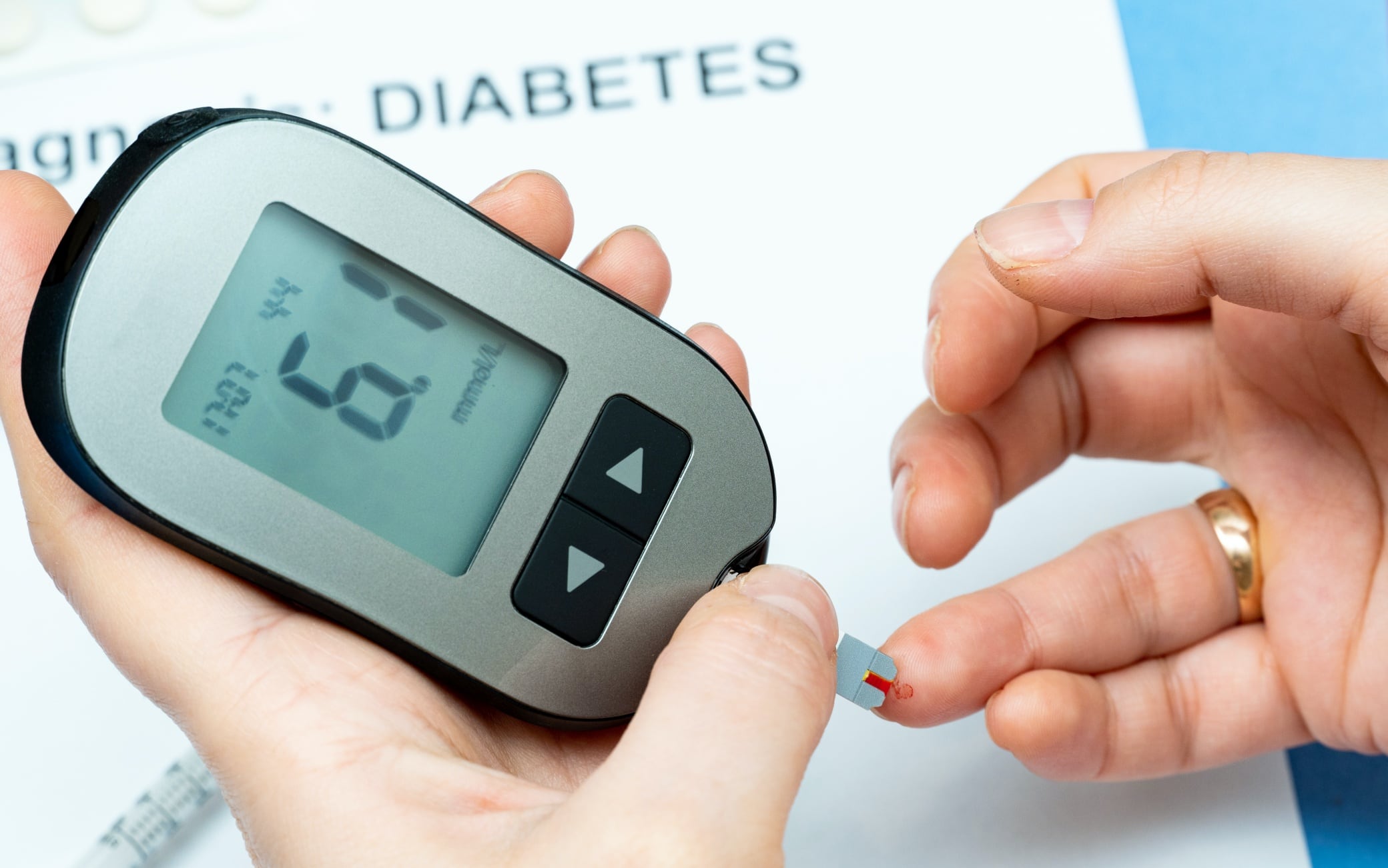 Taking blood from finger for sugar level medical test