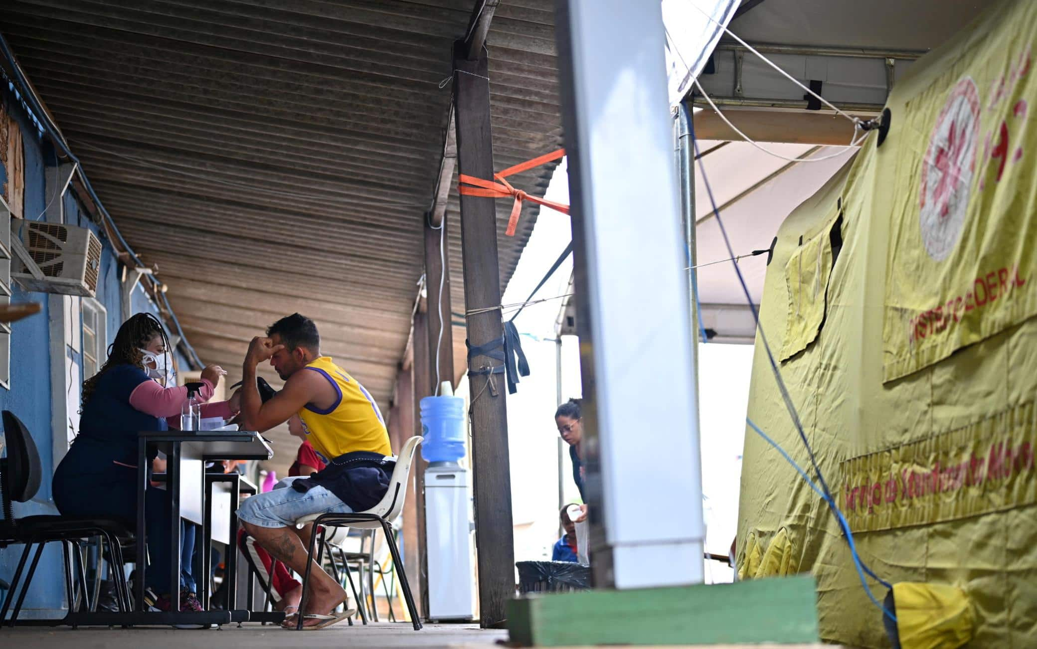 epa11172573 People receive medical attention in a tent to treat suspected cases of dengue, in the administrative region of Sao Sebastiao, on the outskirts of Brasilia, Brazil, 20 February 2024 (issued 22 February 2024). In the midst of the worst peak in recent years, Brazil is fighting dengue door-to-door with fumigations and awareness campaigns among the population that seek to end the country's number one public enemy: the Aedes aegypti mosquito. So far this year, 715,000 cases and 135 deaths have been reported throughout Brazil, and another 481 deaths that could be related to the disease are being investigated, according to the latest figures from the Ministry of Health. EPA/Andre Borges