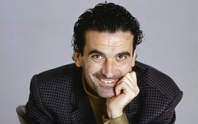 Italian actor and director Massimo Troisi smiling sitting on a chair. 1989 (Photo by Rino PetrosinoMondadori via Getty Images)