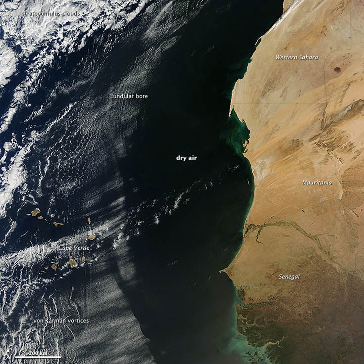 An annotated satellite image taken off the coast of Africa showing wavy and wispy clouds.