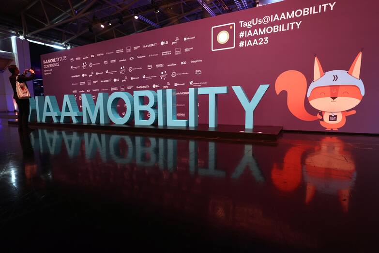 epa10841269 A man takes a photo of an IAA Mobility sign at the International Motor Show (IAA) in Munich, Germany, 05 September 2023. The 2023 International Motor Show Germany IAA MOBILITY 2023 takes place in Munich from 05 to 10 September 2023. The IAA 2023 will also feature numerous world premieres, and has a special focus on electric mobility and digitization. EPA/ANNA SZILAGYI