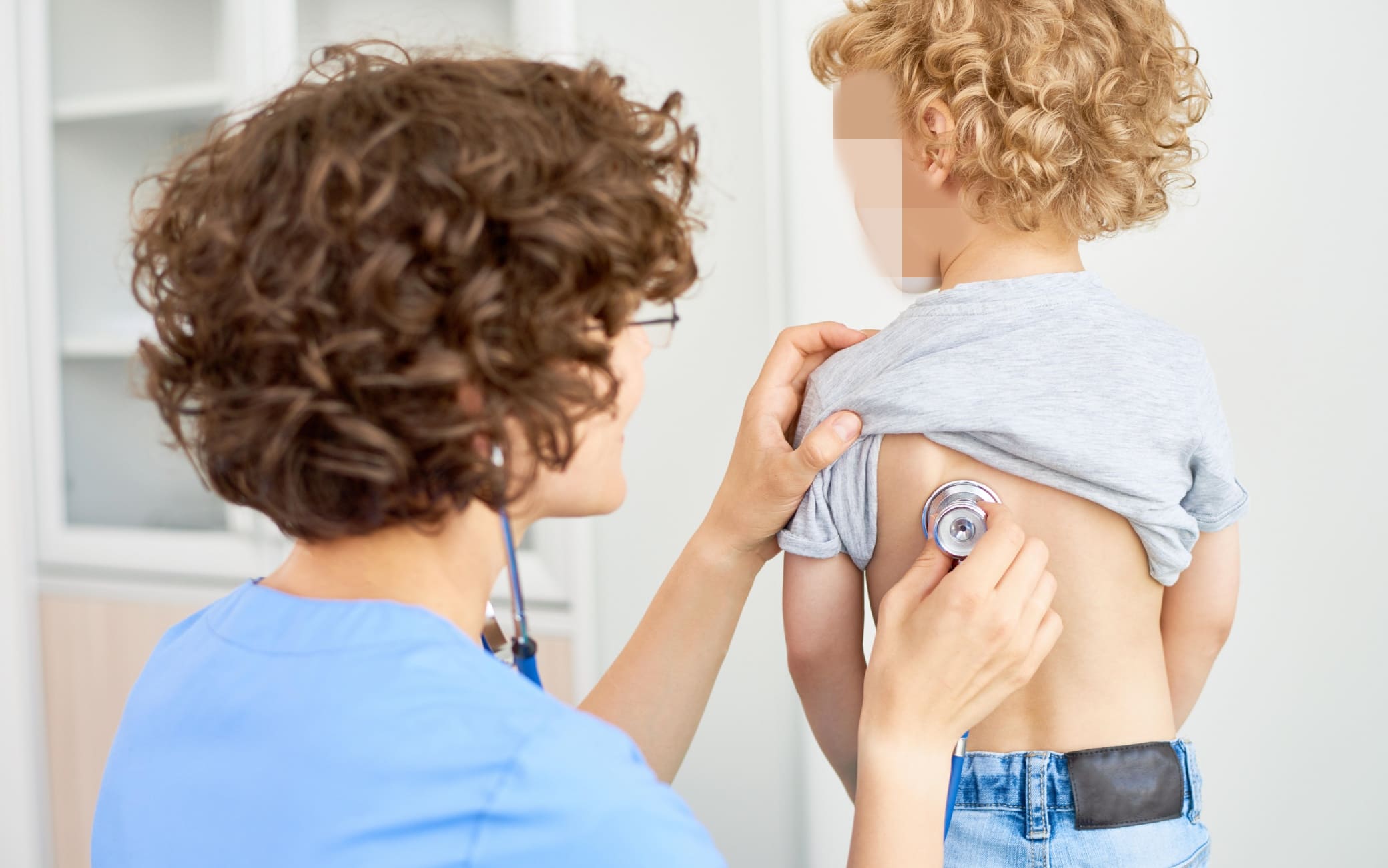 Pediatrician Listening to Boys Breathing