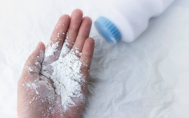 Baby powder on mother's hand, dust dangerous for health concept.